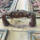 Front door of a house or building in the city centre, with a dolphin door knocker and frame + transom.