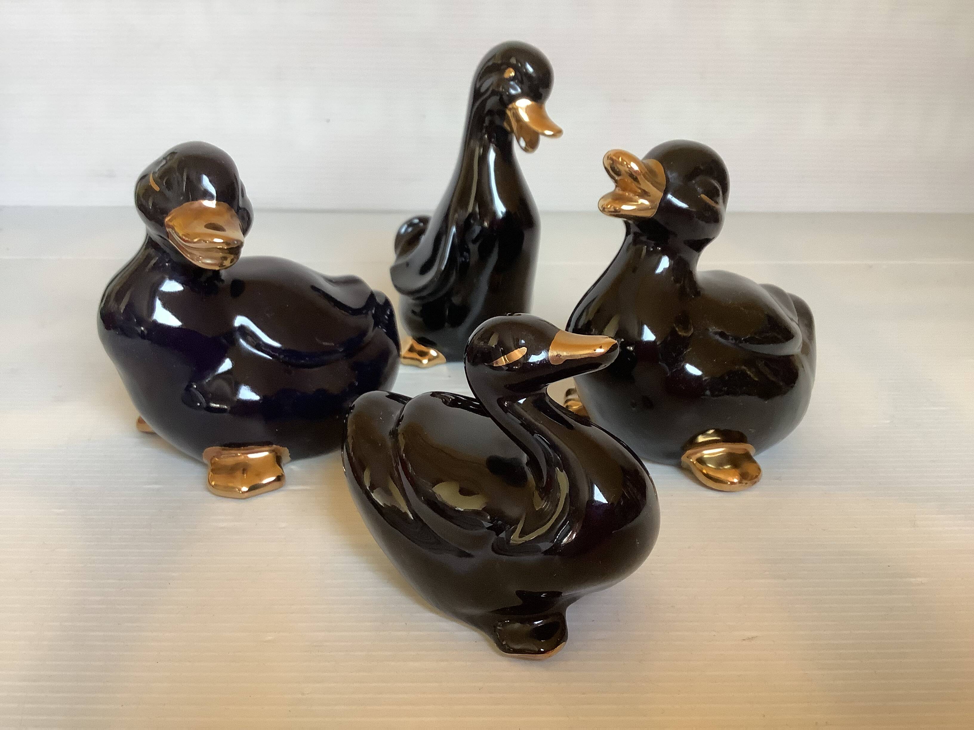 Four little black and golden ducks.