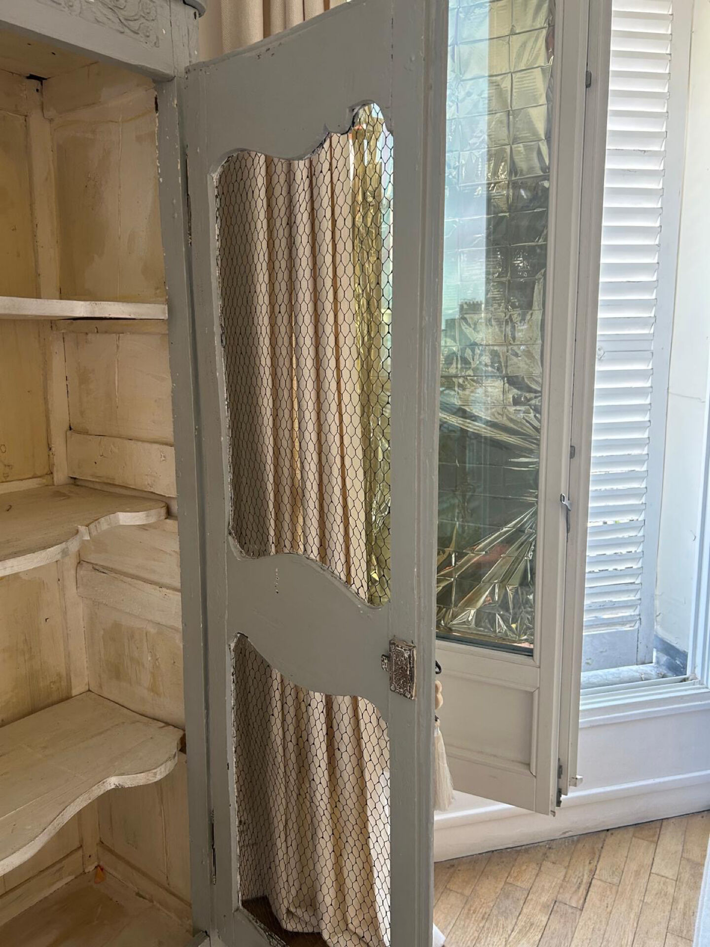 Antique French carved display cabinet with wire mesh doors