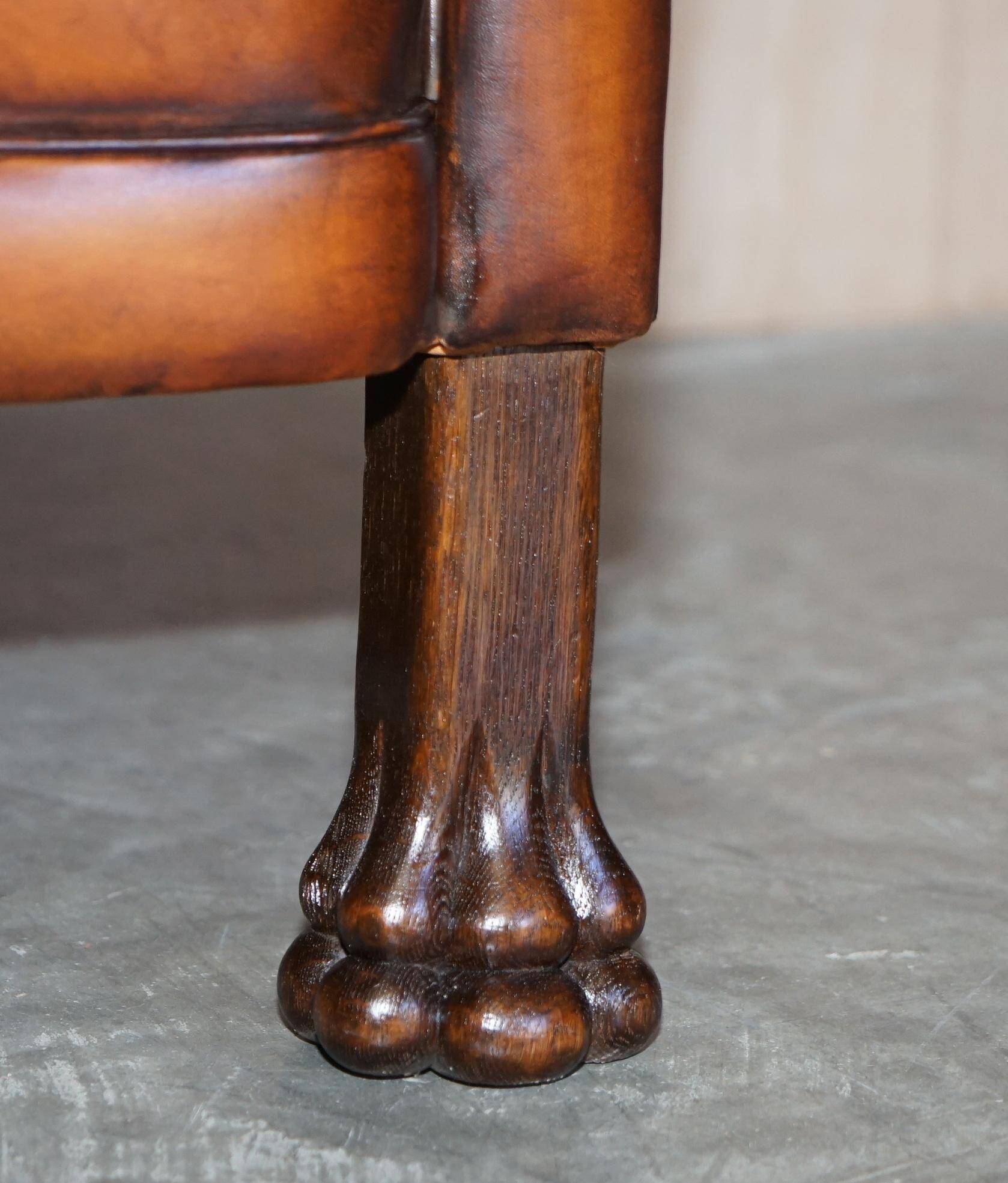 Victorian Chesterfield leather canapé with oak lion claw feet.