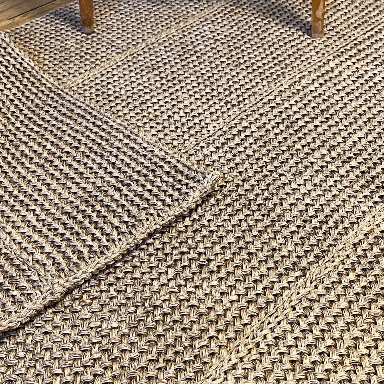 Handmade carpet in natural fiber of knitted palm leaf