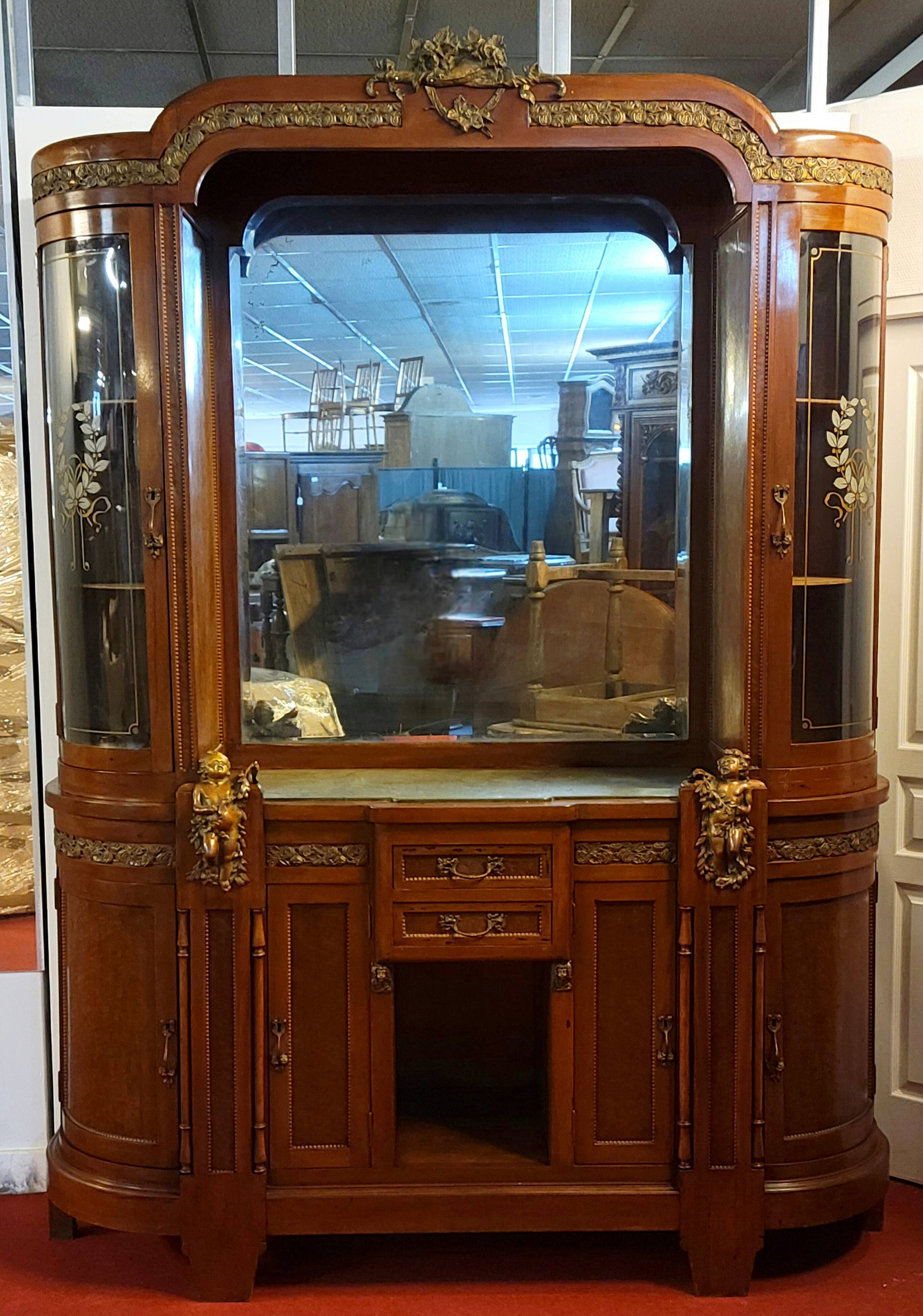 Empire style half-moon shaped mahogany bookcase with putti