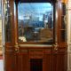Empire style half-moon shaped mahogany bookcase with putti