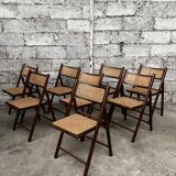 Serie de 8 chaises pliantes vintage en bois et cannage 1960
