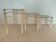 Nested tables by Boutboul in cream metal and smoked glass, circa 1970.