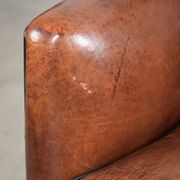 Comfortable sheepskin armchair in unique design finished with black piping