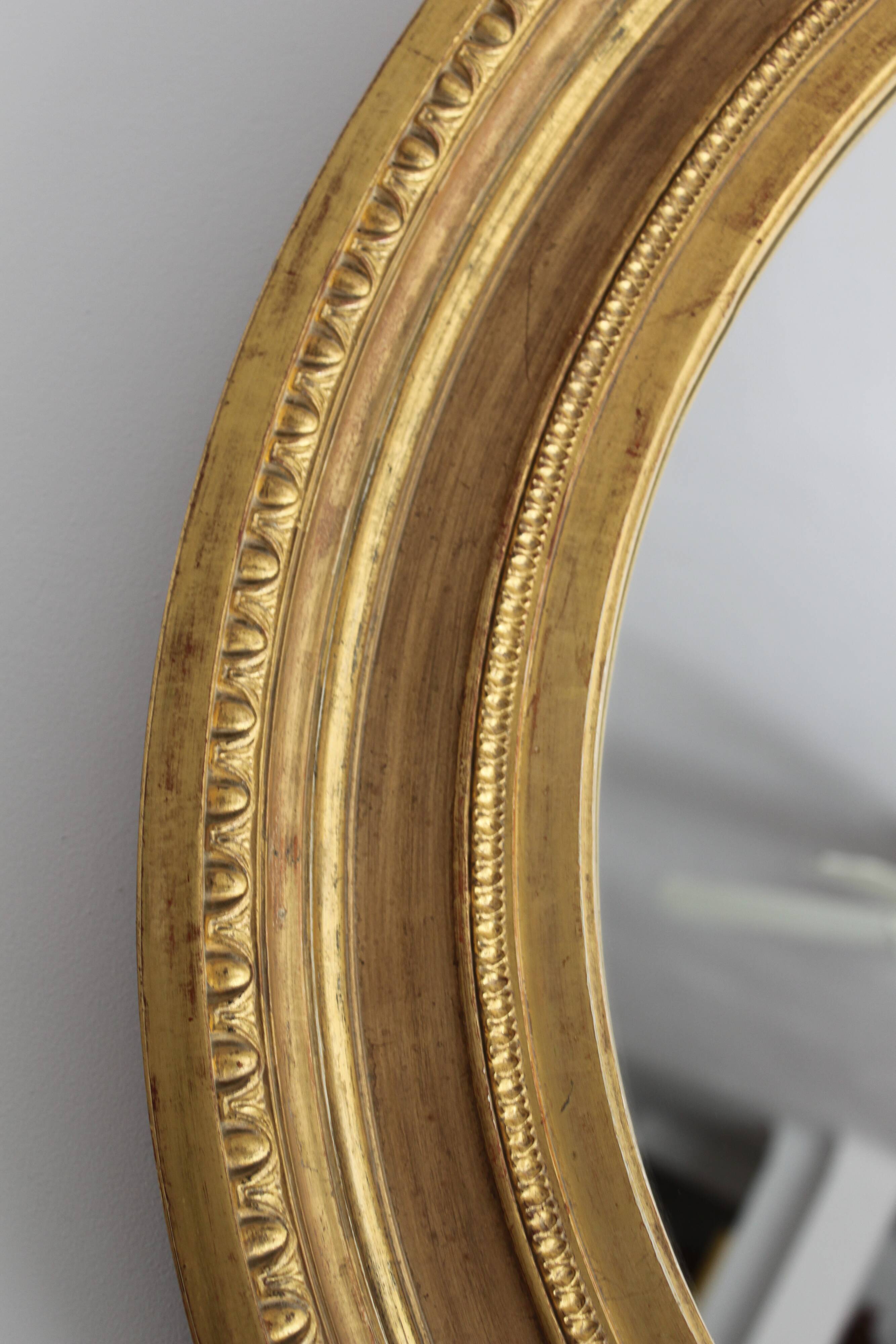 Mirror antique medallion gilded with gold leaf
