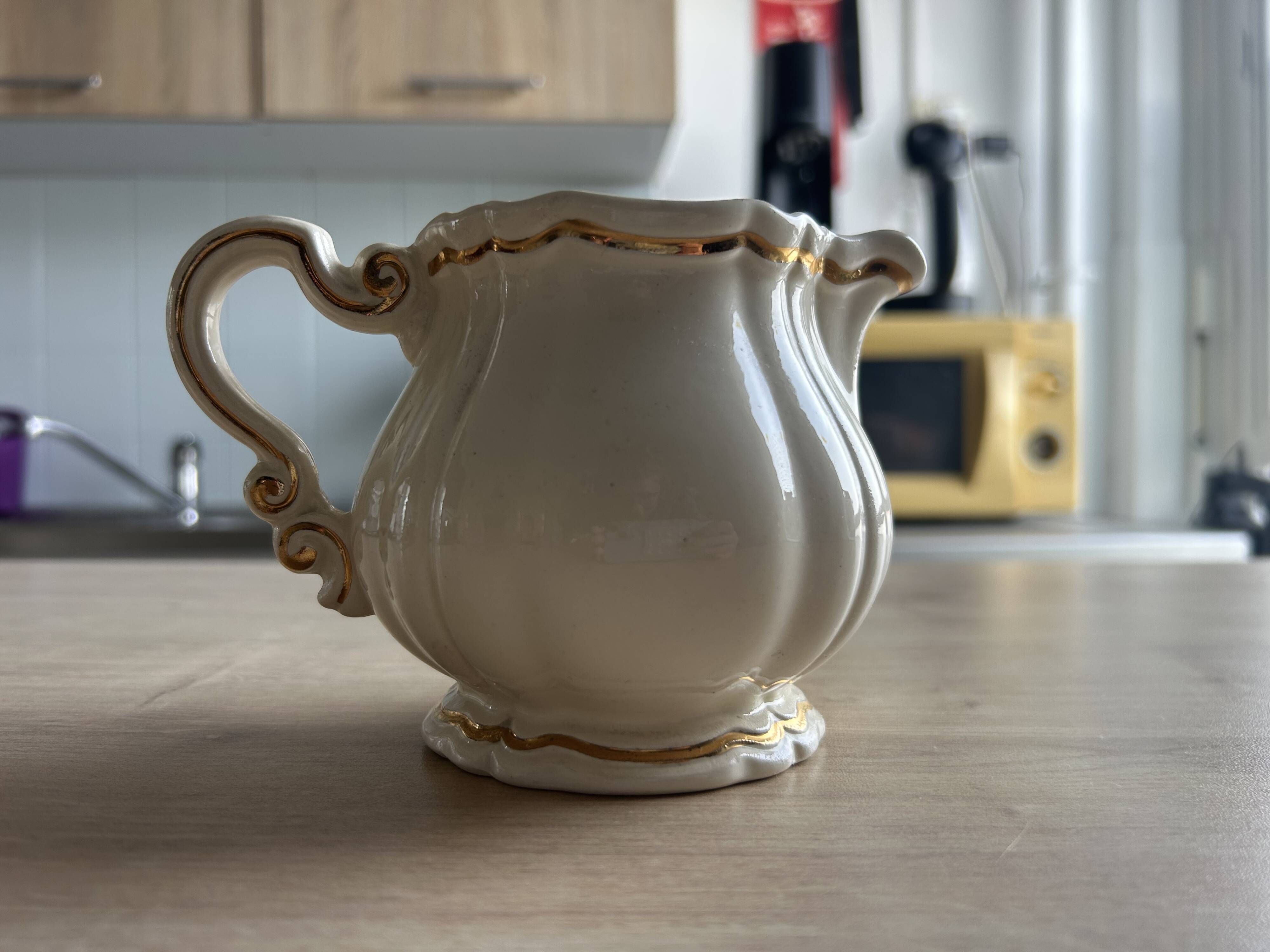 Old cream jug "Nous deux" in Sarreguemines earthenware.