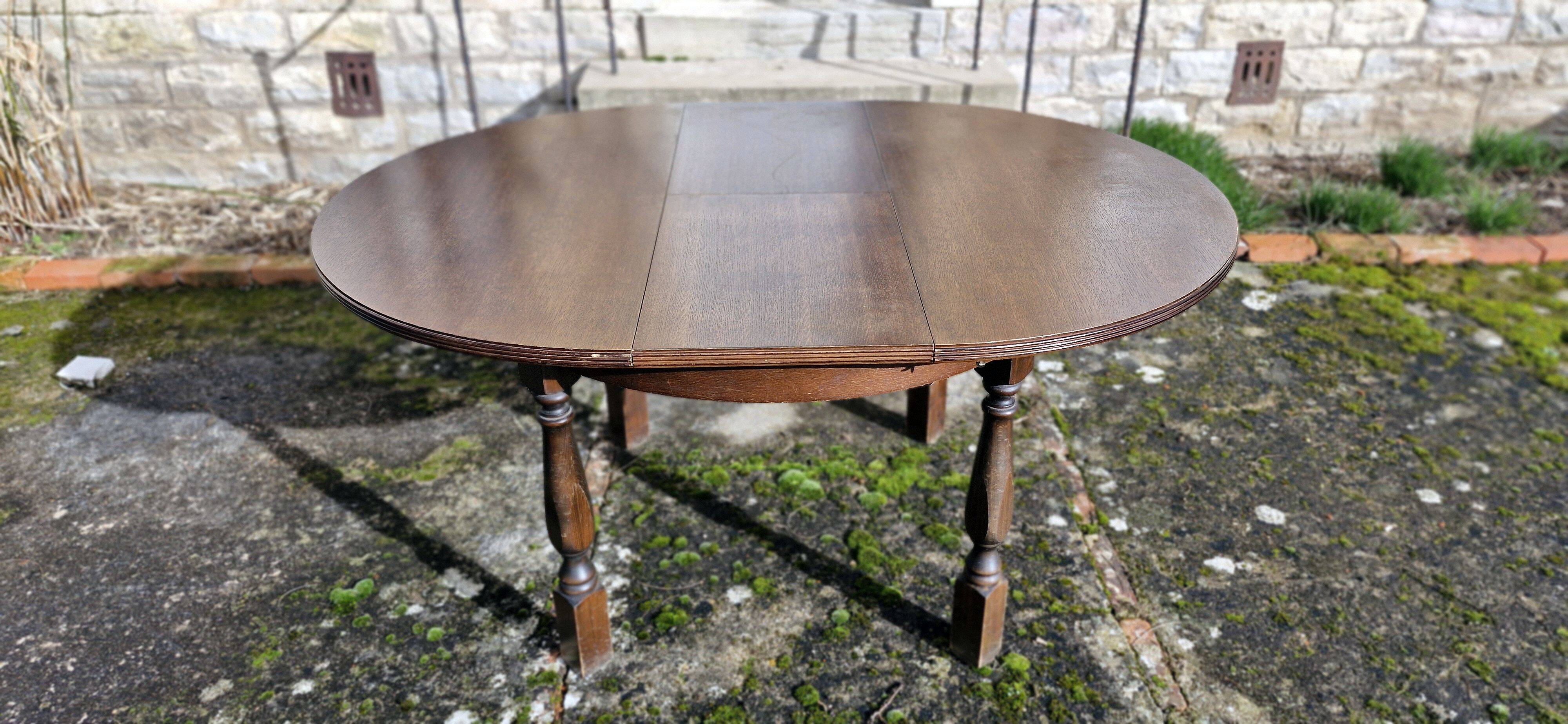 Round wooden table with 1 integrated extension + 6 wooden and fabric chairs