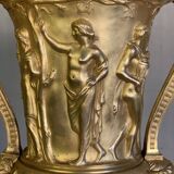 Golden bronze urn, base of red griotte marble.