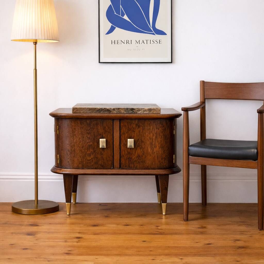 Small vintage 1950s wooden buffet with marble top and tapered legs.