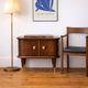Small vintage 1950s wooden buffet with marble top and tapered legs.