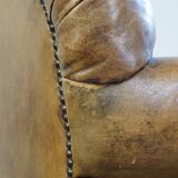 Fauteuil ancien en cuir de mouton