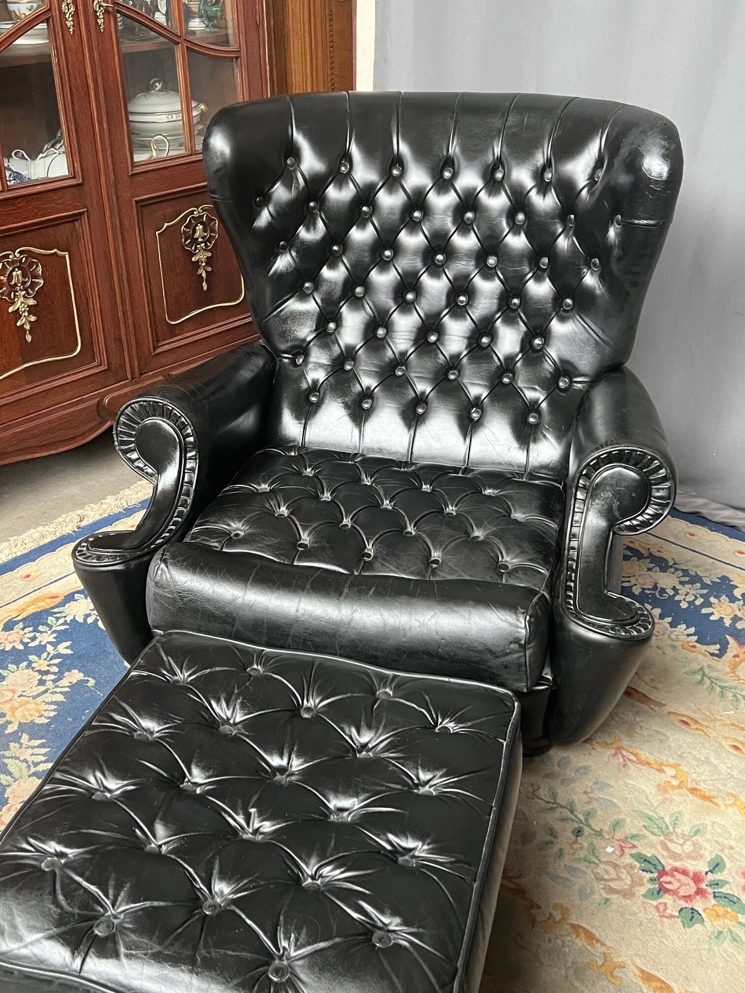Chesterfield armchair and ottoman. Leather.
