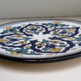 Round ceramic plate with hand-painted decoration