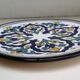 Round ceramic plate with hand-painted decoration