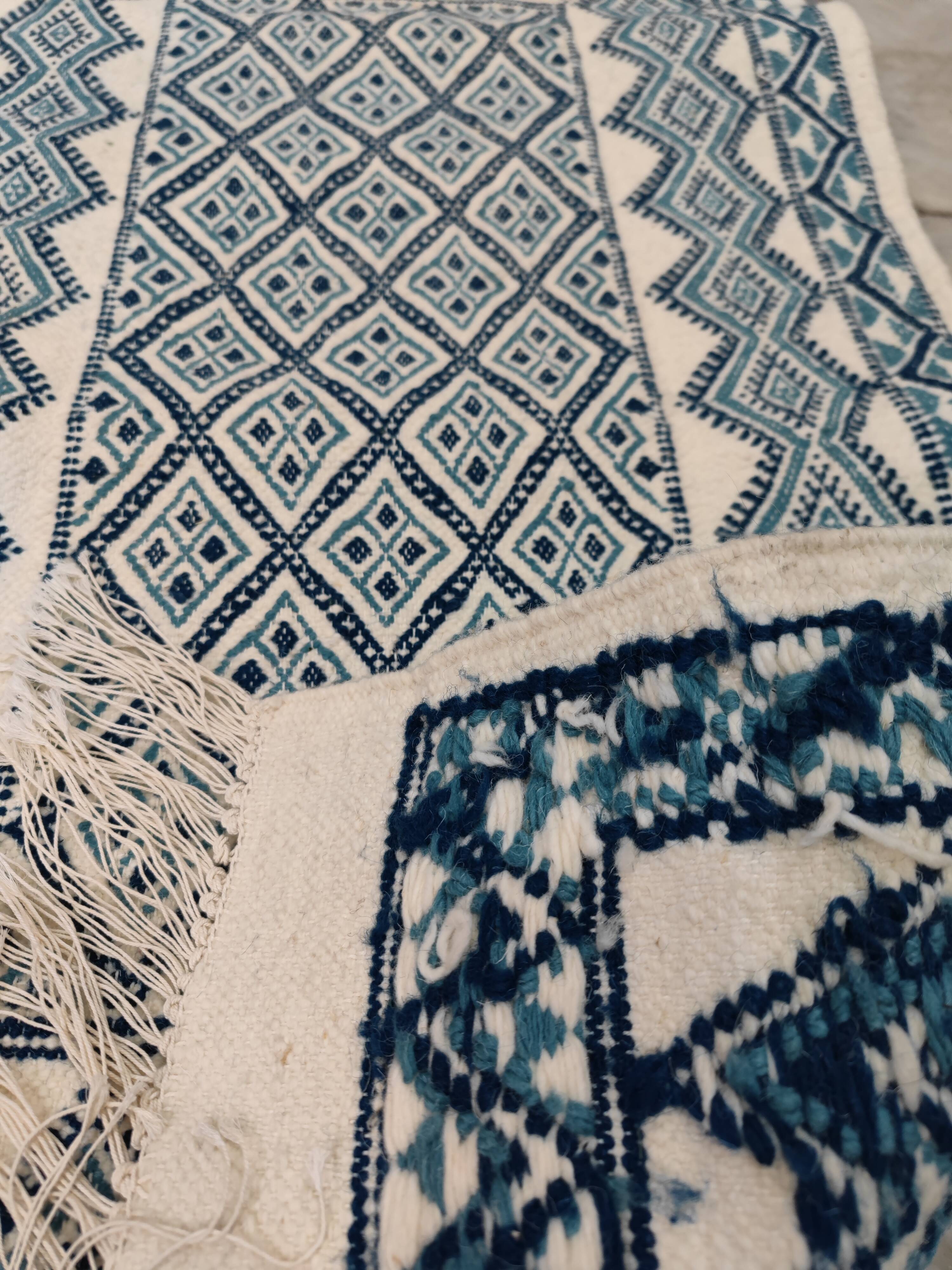 White and blue hand-woven rug in natural wool