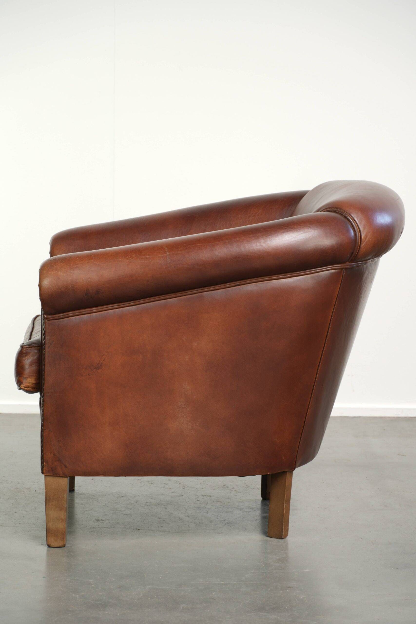 Sheepskin club armchair in English style with brown colour scheme