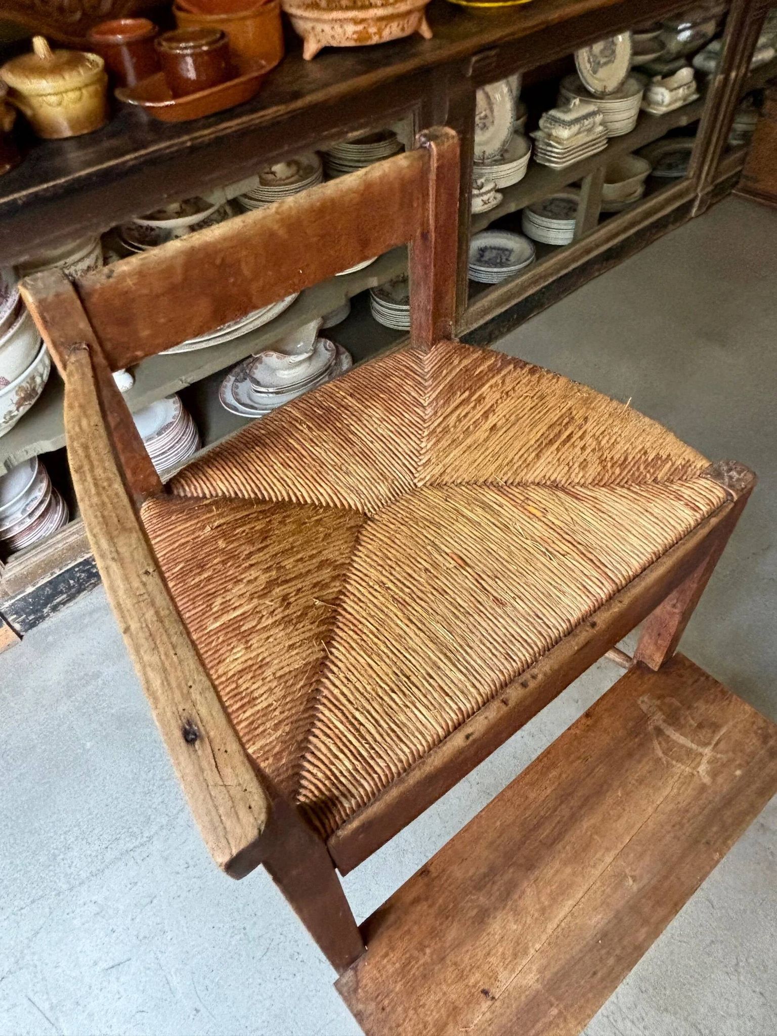 High chair made of wood and straw.