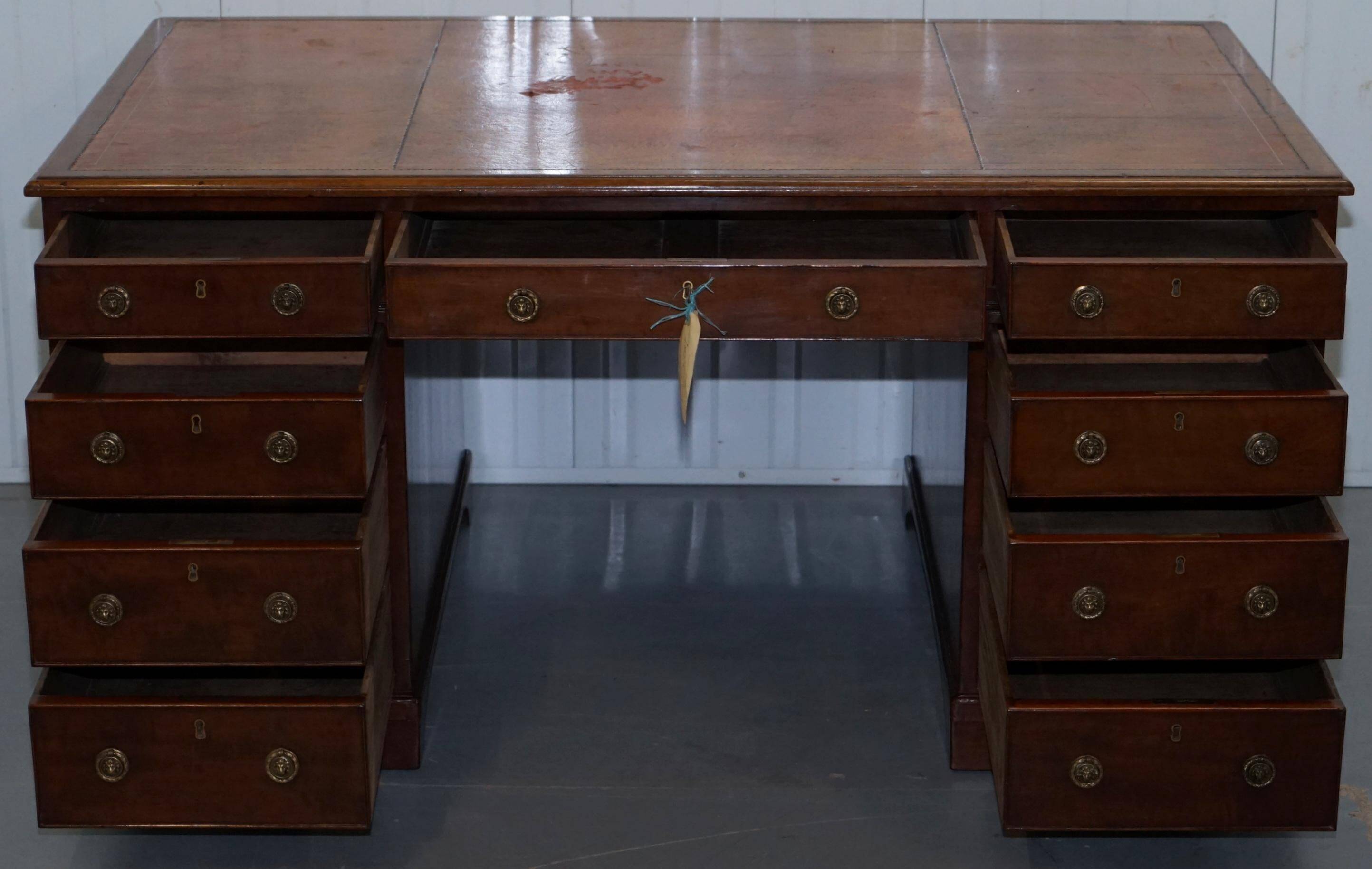 Double-sided partner's desk in walnut, George III, circa 1780, with lion head handles.