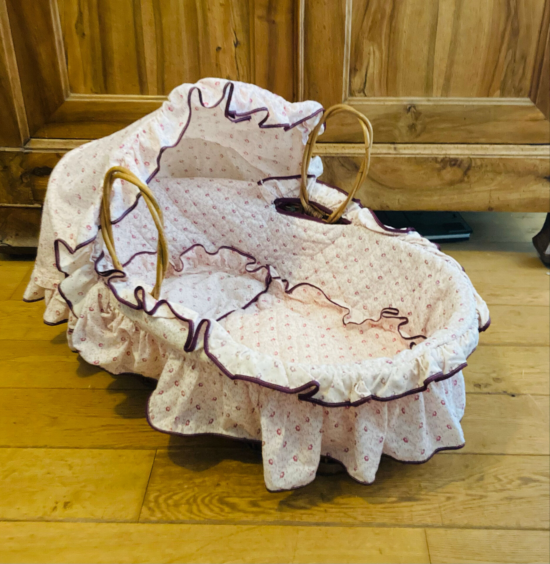 1960s wicker cradle with mattress and drapes.