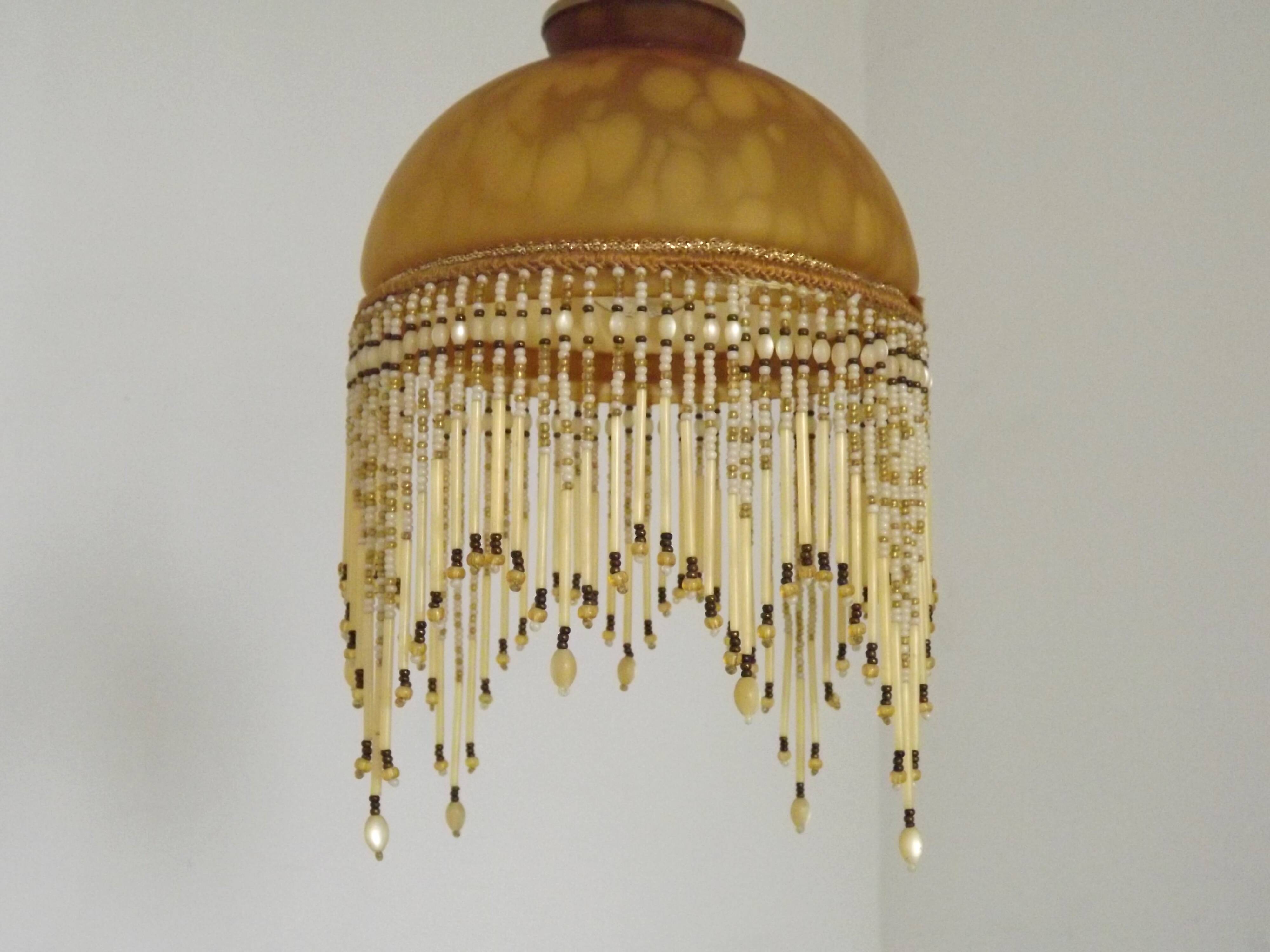 Vintage French amber mottled glass hanging ceiling light with beaded fringe.