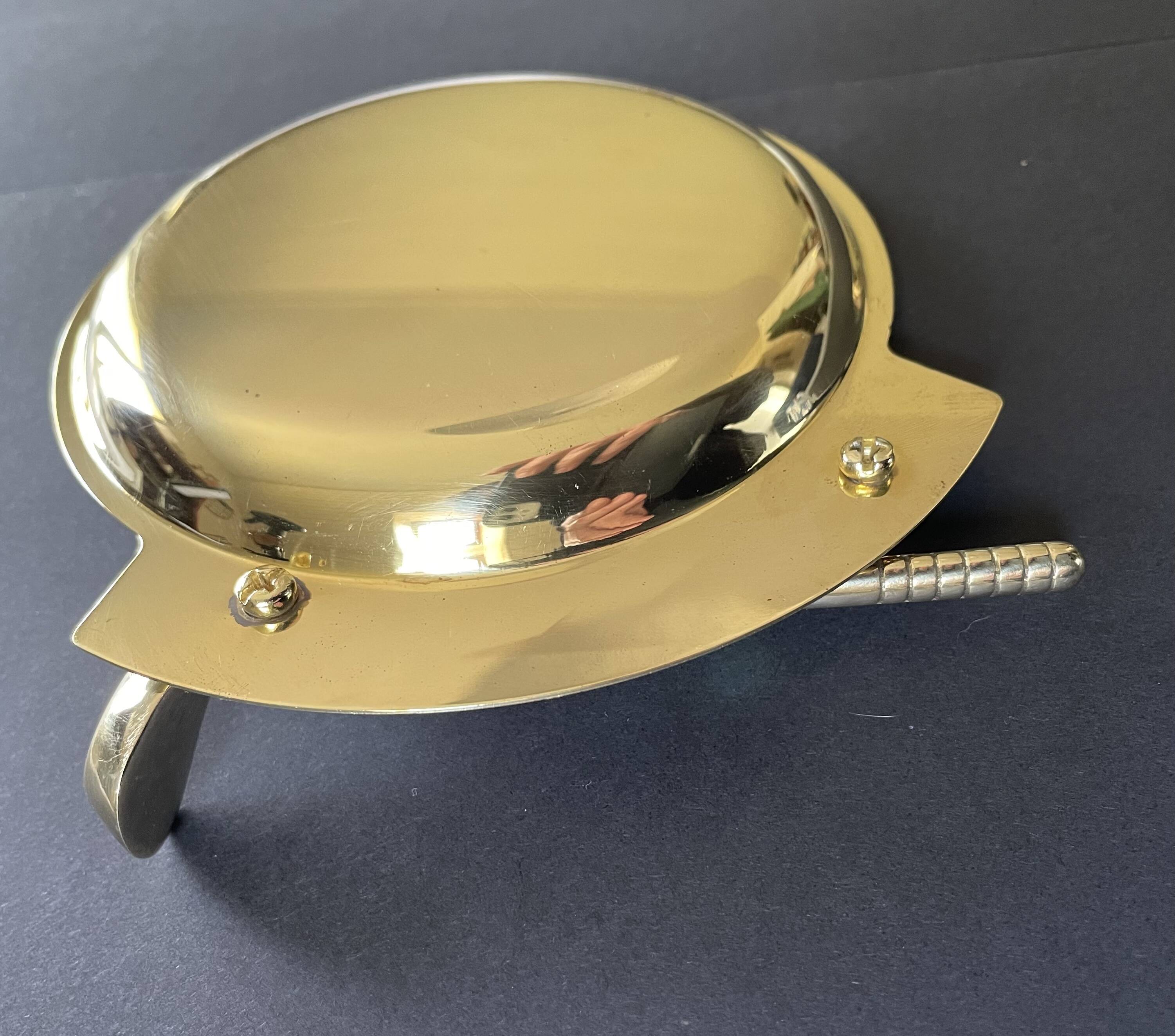 Round brass pocket tray with club and golf ball decoration.