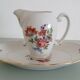 Pot à lait et son plat de présentation en porcelaine émaillée de Limog
