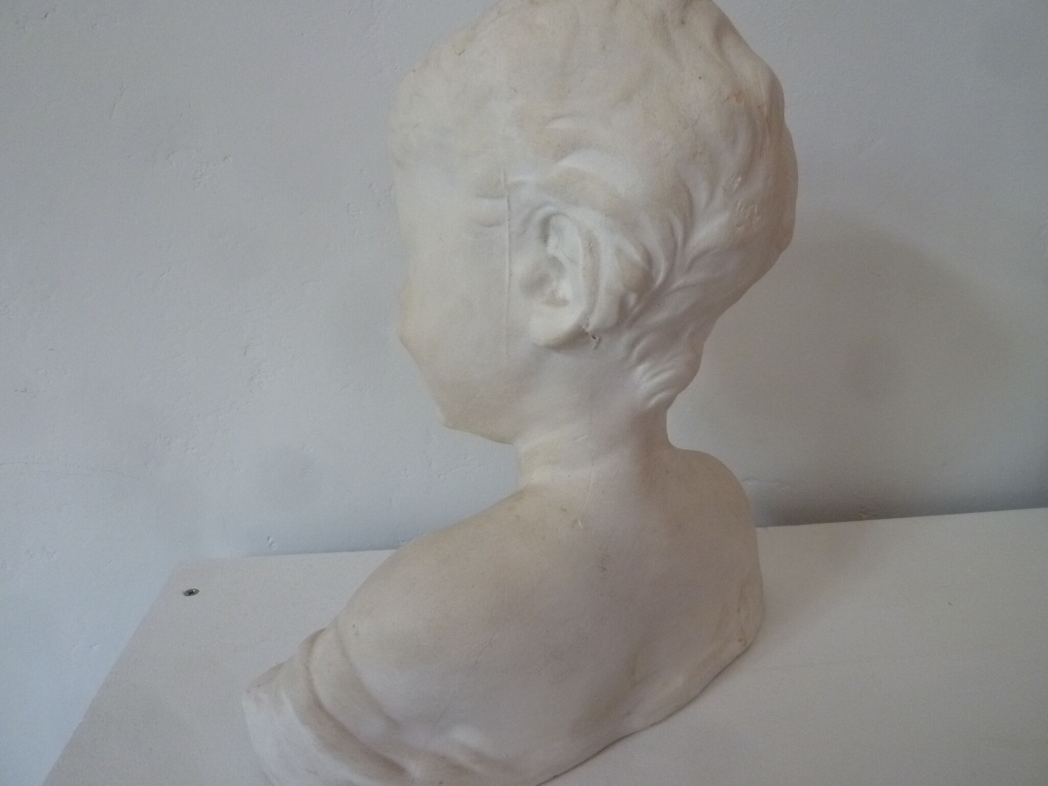 Bust young boy in plaster
