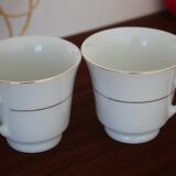 Set of 2 white porcelain cups with gold rim