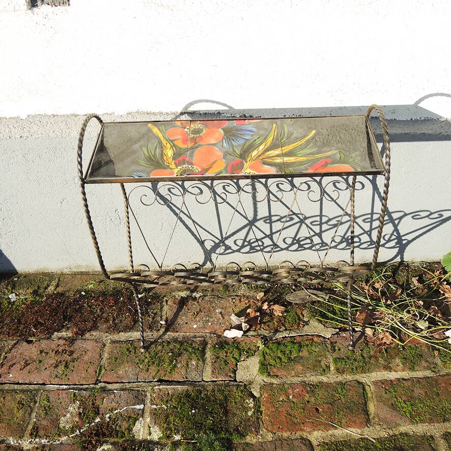 Antique wrought iron and ceramic magazine rack