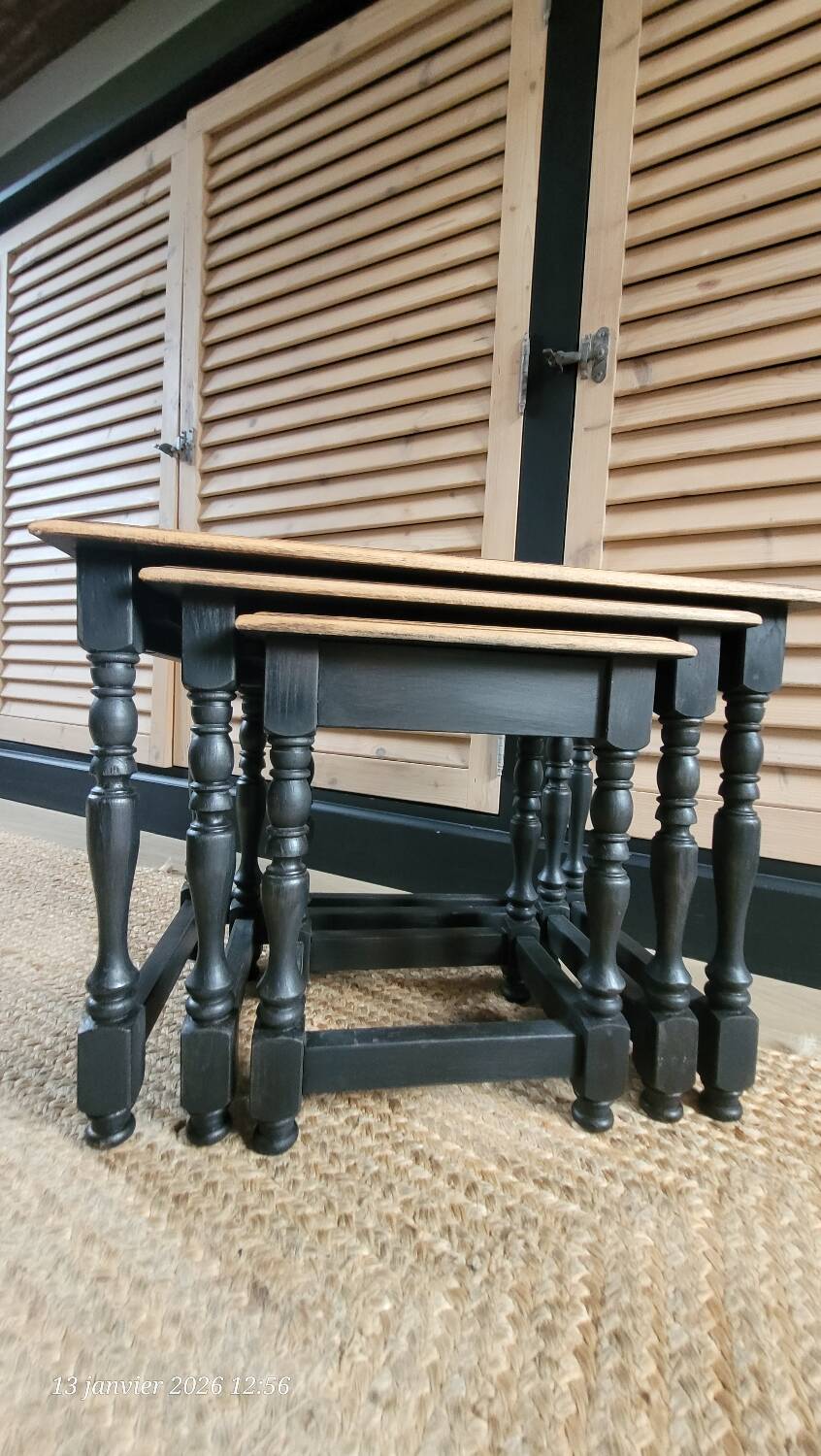 Nest tables in wood and black.