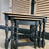 Nest tables in wood and black.