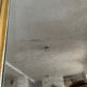 Large antique baroque mirror with angel decorations.