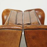 Set of 2 very comfortable large sheepskin armchairs elegantly finished with black piping