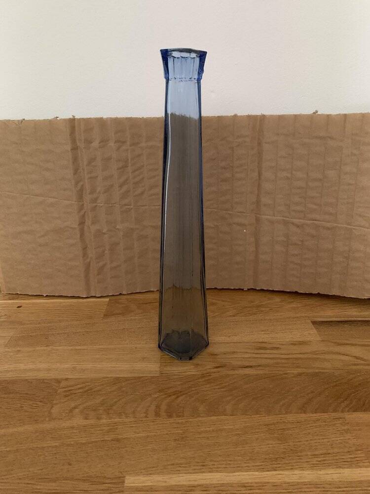 Translucent blue glass vase from the 1980s — tall prismatic silhouette, polygonal base.