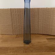 Translucent blue glass vase from the 1980s — tall prismatic silhouette, polygonal base.