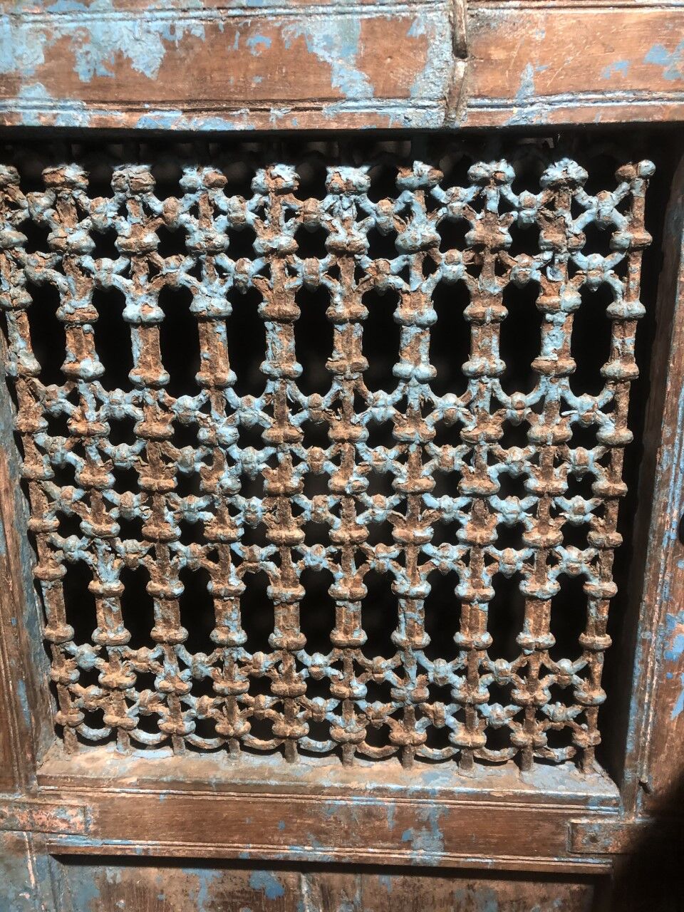 Openwork indian door in metal and blue wood