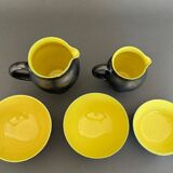 Two pitchers and three Elchinger ceramic bowls black and yellow background 1960