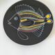 Black faience plate with stylised fish, Ty Breiz spirit from the 1960s.