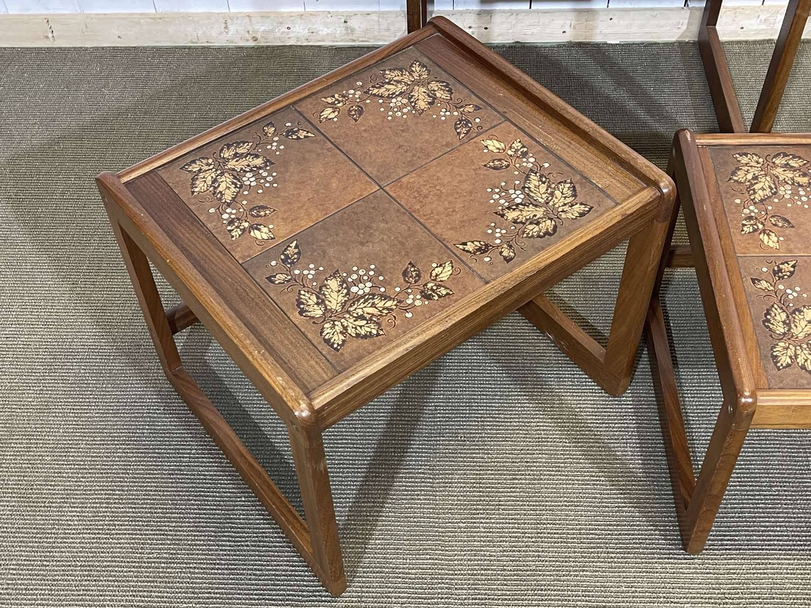 Set of 3 nesting tables in teak with tiled tops.