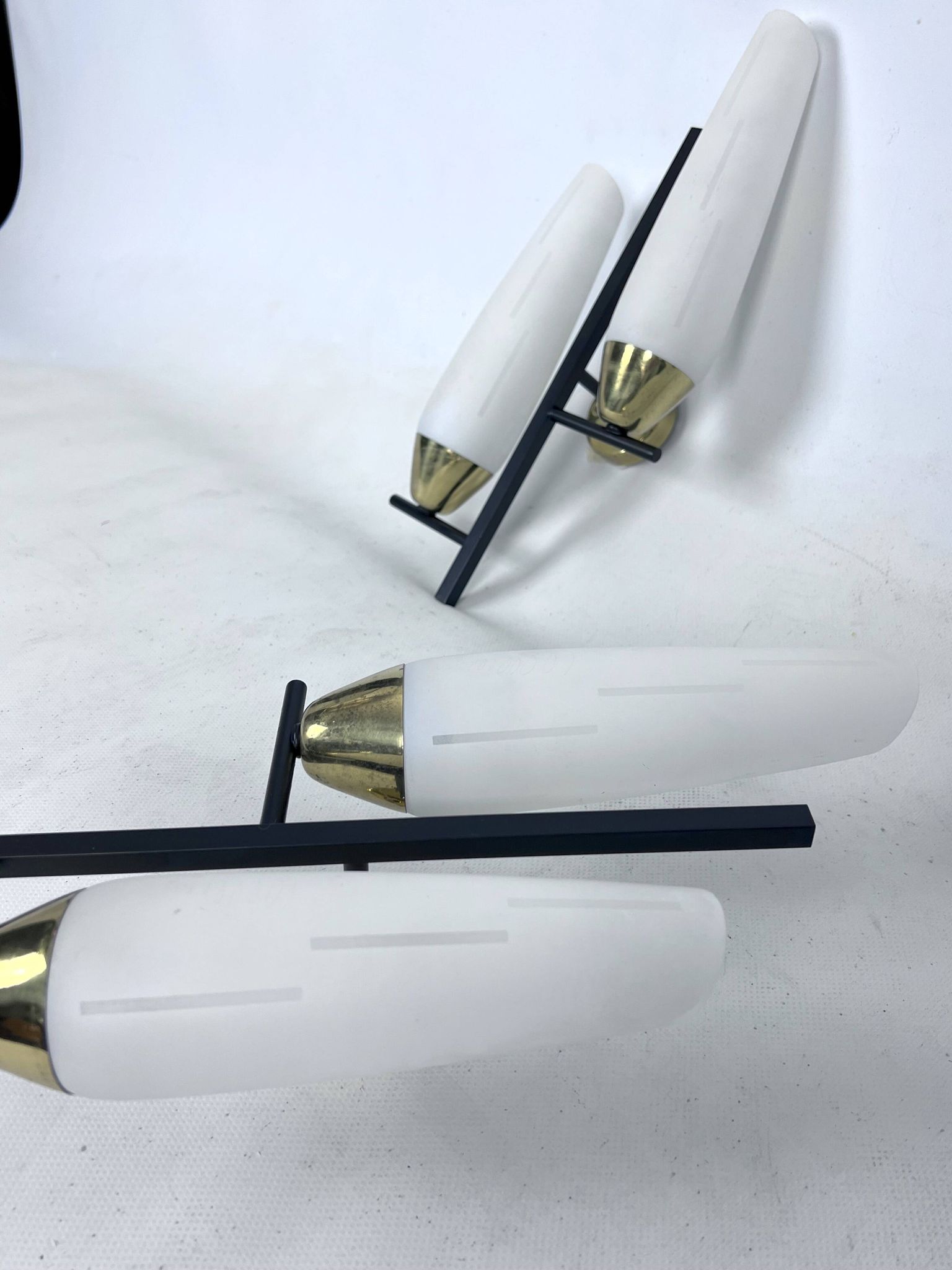 Mid-Century pair of double lights sconces in brass and opaline glass. Italy 1950s