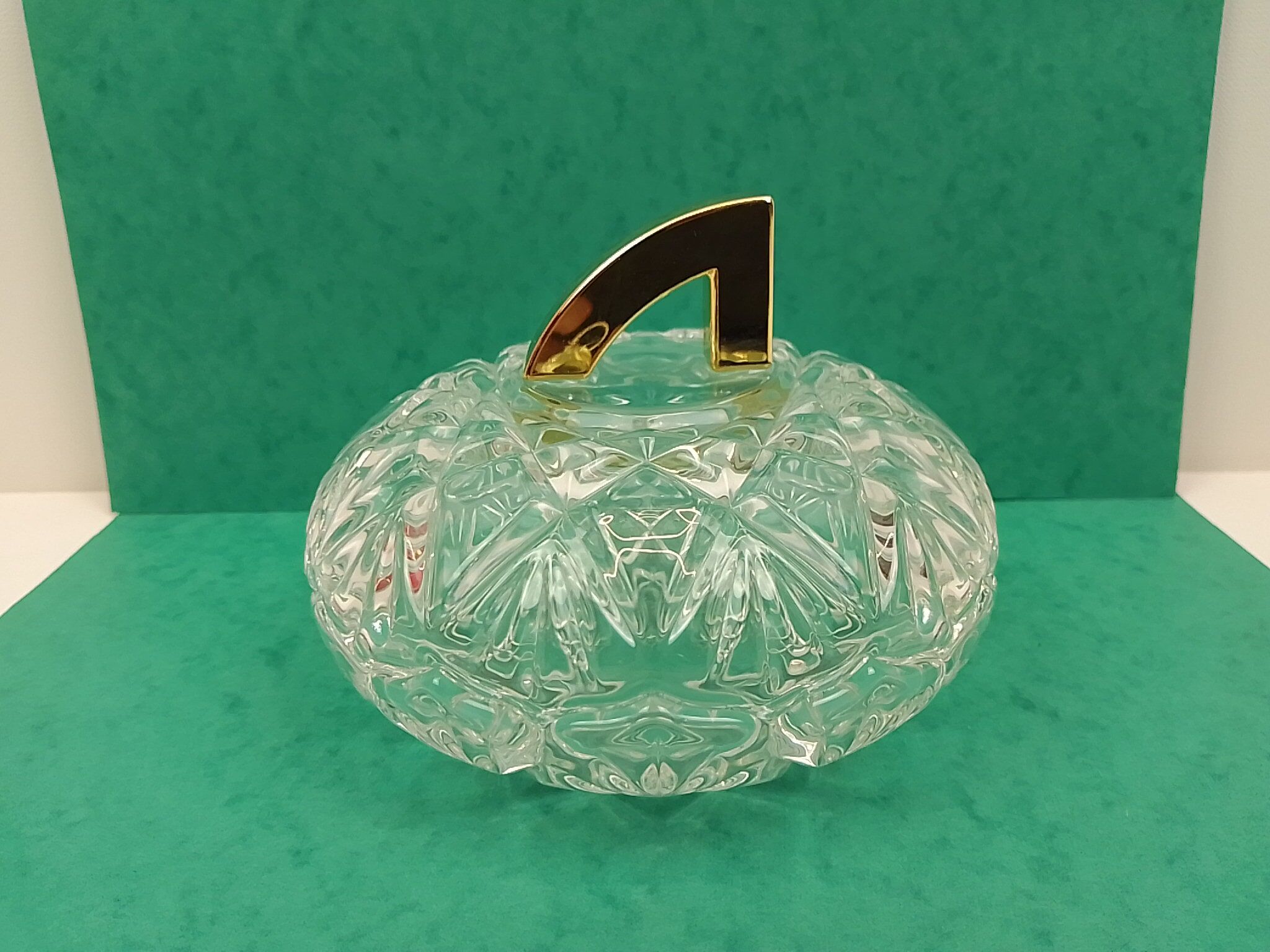 Round crystal box and a golden metal handle