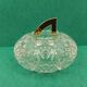 Round crystal box and a golden metal handle