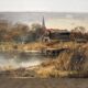 Village by the water, oil on paper signed