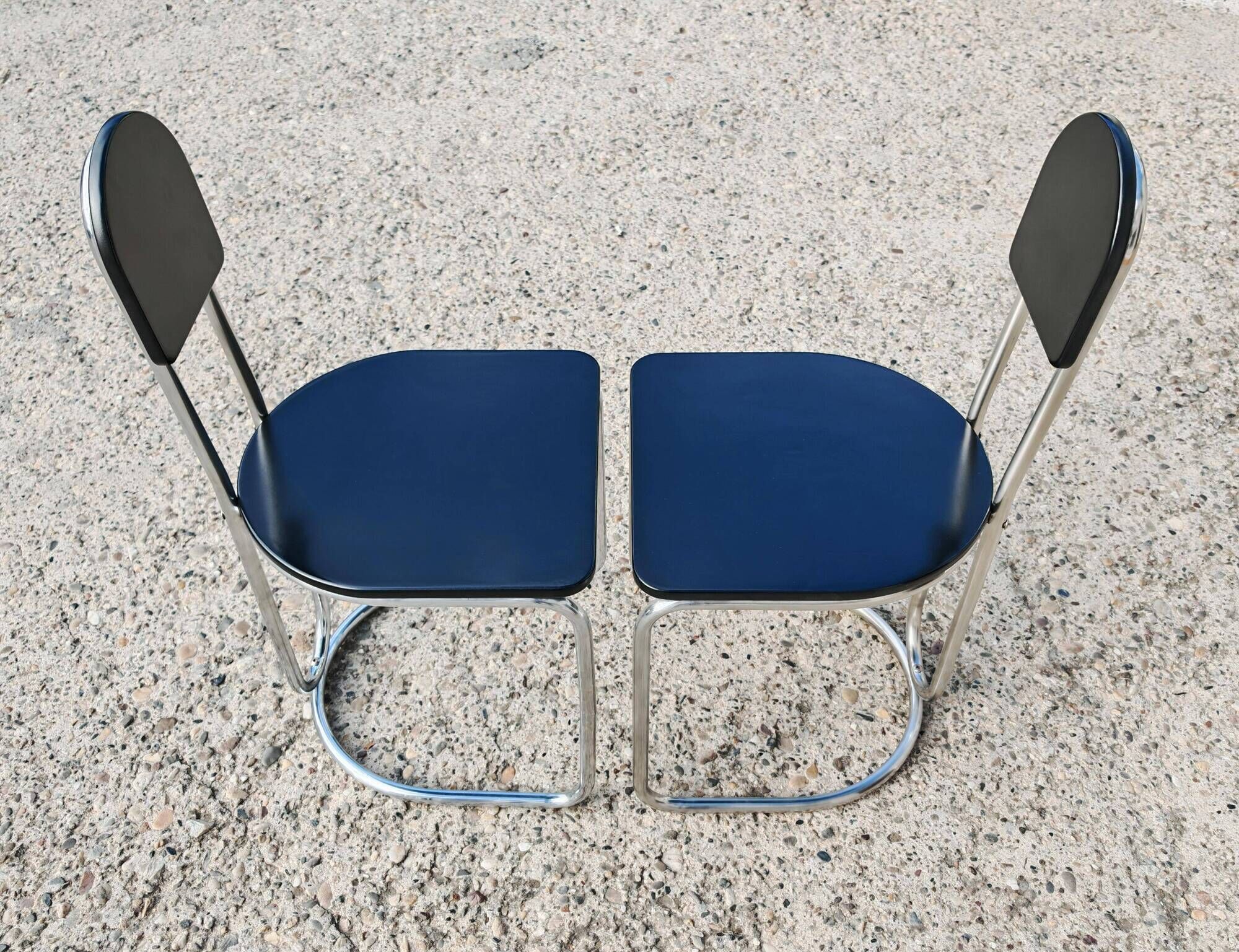 Set of 4 Bauhaus tubular steel chairs with wooden seats.