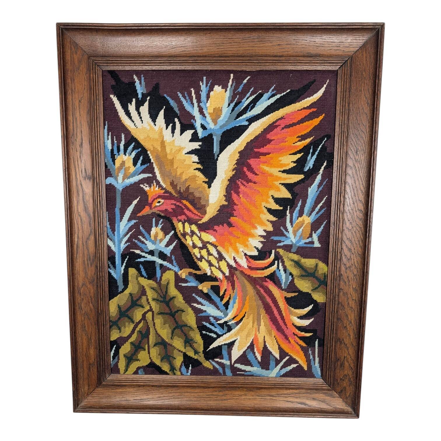 Framed embroidered canvas of a firebird.