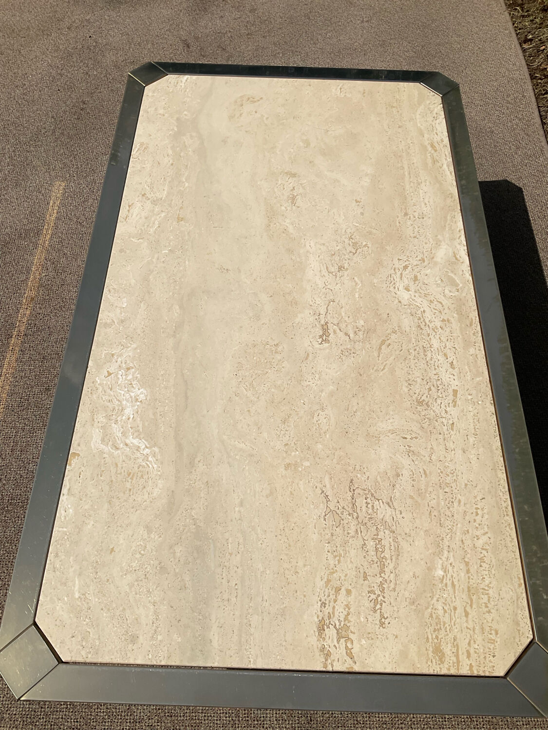 Vintage coffee table in travertine and brass.