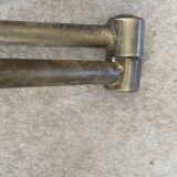 Adjustable wall light in brass and gold metal.