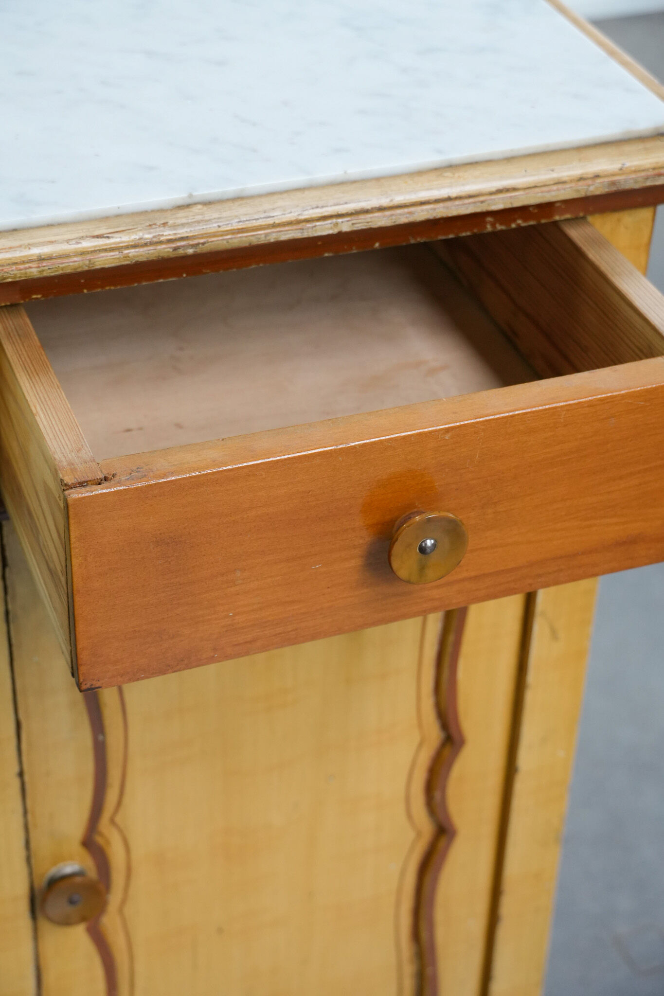 Antique wooden 1-door hallway/nightstand with a light marble top